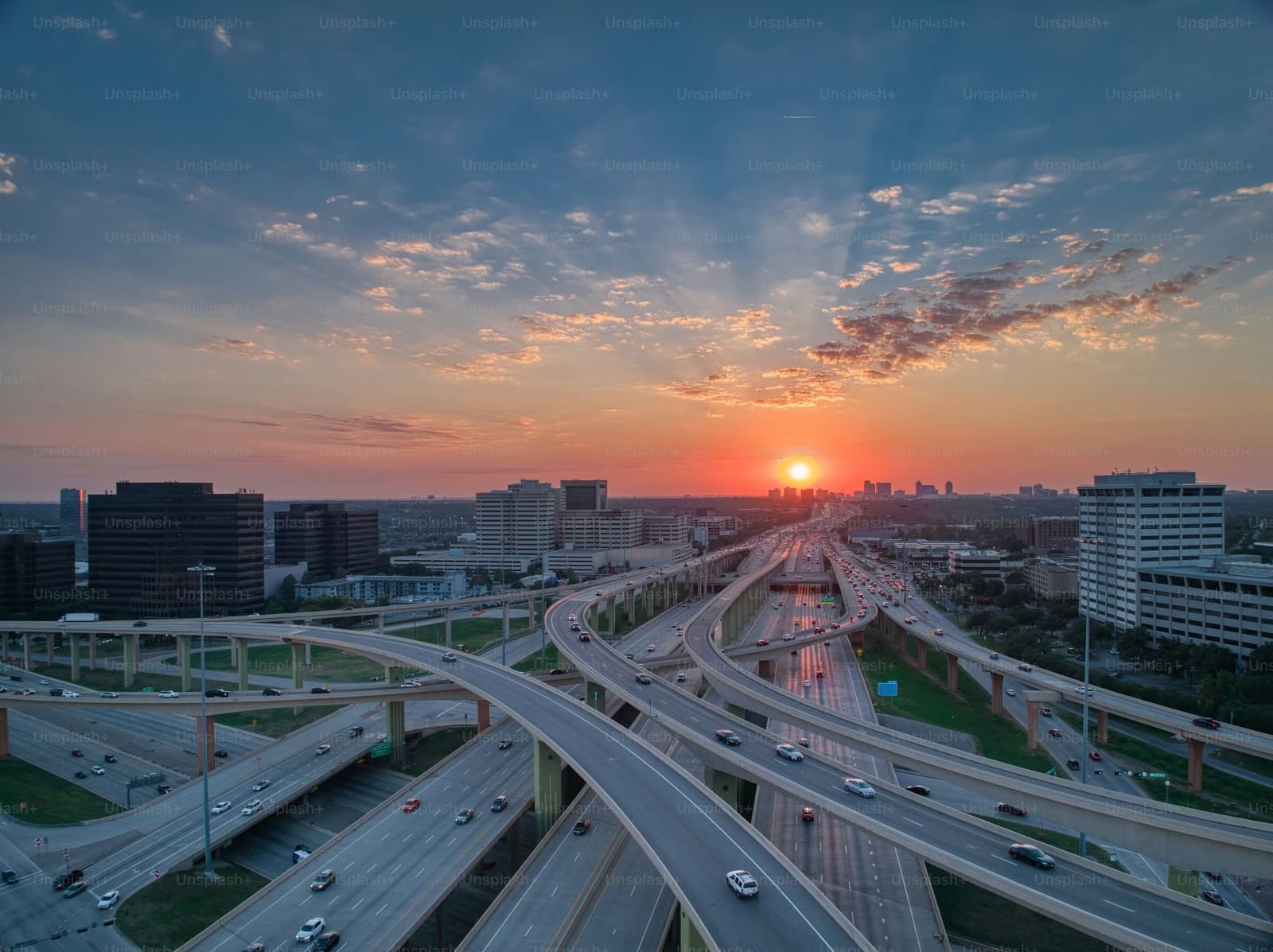 Aerial view of a U.S. highway interchange at sunset — the infrastructure Metro Associates staffs